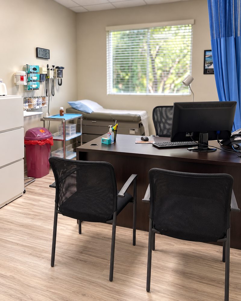 Private consultation room with a desk and examination bed in Miami Lakes
